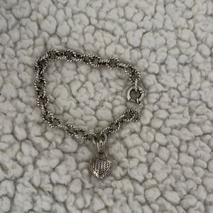 Sterling silver heart bracelet with 14 karat gold, and diamond accents.